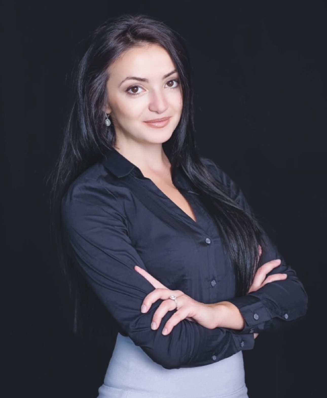 Head-and-shoulders portrait of Ivanna Andrusyak, long dark hair, wearing a black button-up shirt.