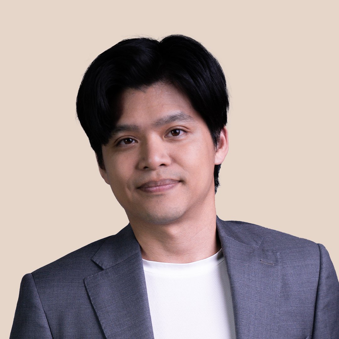 Head-and-shoulders portrait of Jackson Ho, short dark hair, wearing a grey jacket over a white top.