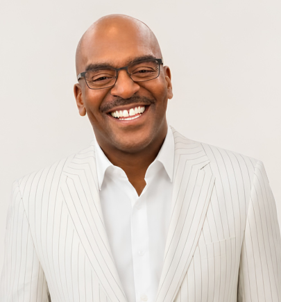 Head-and-shoulders portrait of Jason McDonald, bald, wearing glasses and a white pinstriped blazer.