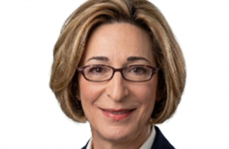 Head-and-shoulders portrait of Mina Nadimi, shoulder-length blonde hair, wearing glasses and a dark blazer.