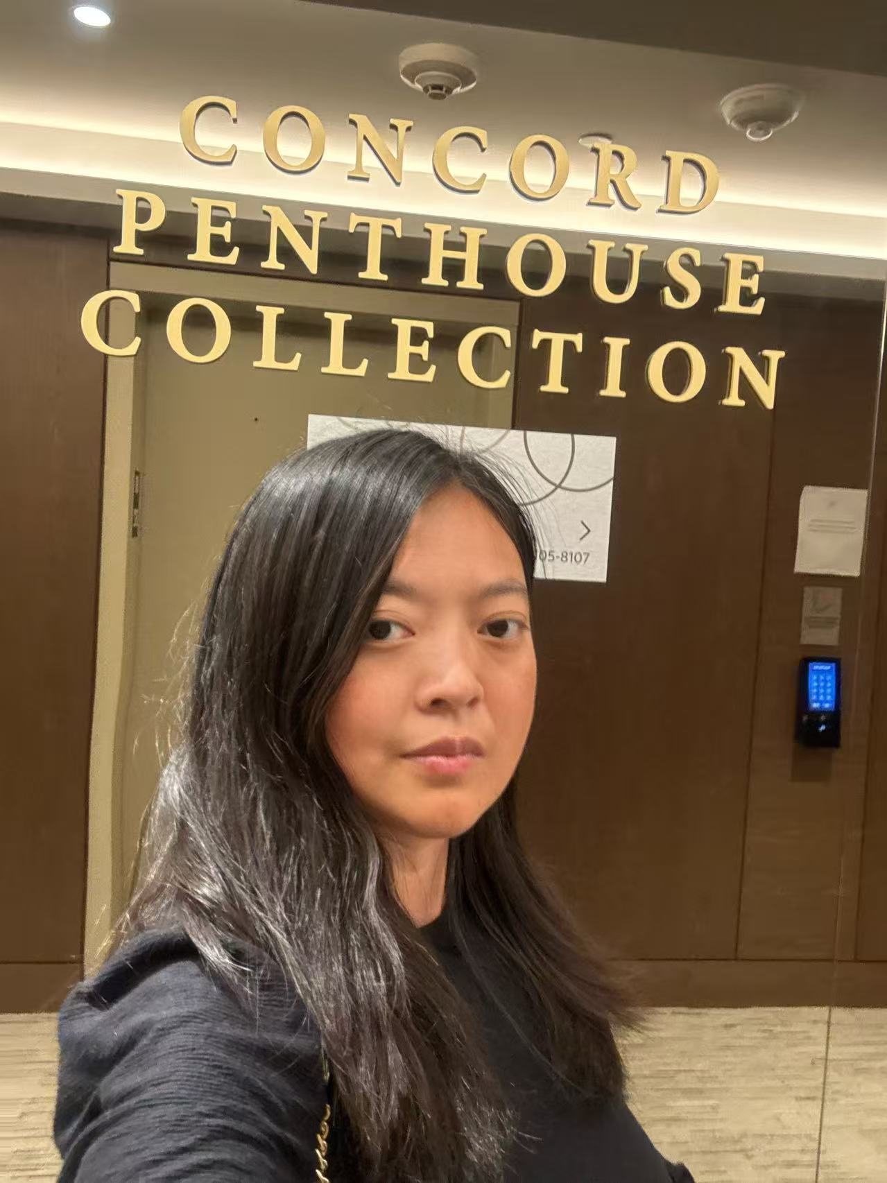 Head-and-shoulders portrait of Xue Ding, long dark hair, wearing a dark top.