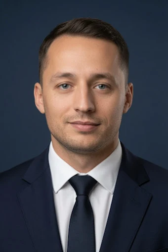 Head-and-shoulders portrait of Ivan Voitsytskyi, short brown hair, wearing a dark suit, white shirt, and navy tie.
